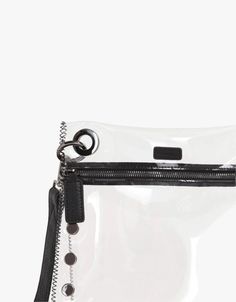 The Tony Clear Medium Handbag is a seamless blend of fashion-forward design and practicality. This Stadium-approved accessory is more than just a bag—it's a statement of playful sophistication. Elevate your ensemble now! Modern Pouch Bag For On-the-go, Black Top Handle Pouch For Shopping, Modern Top Handle Pouch With Dust Bag, Modern On-the-go Pouch Bag, Modern Shopping Pouch, Modern Pouch For On-the-go, Modern Clutch With Removable Pouch For On-the-go, Modern Everyday Clutch With Detachable Handle, Functional Shoulder Bag With Gunmetal Hardware