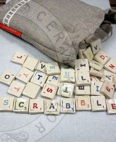 the letters are spelled in small blocks on the table next to a bag and pencil