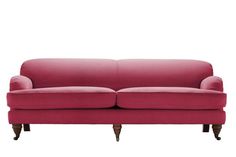 a pink couch sitting on top of a white floor