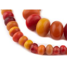 a close up of a necklace made out of fruits and vegetables on a white background