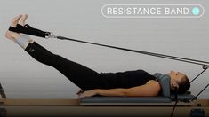 a woman is doing an exercise on a rowing machine with the resistance band attached to her arm