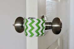 a close up of a door handle with a green and white chevron pattern on it