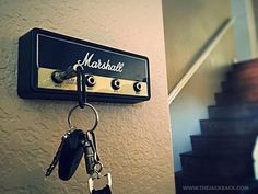 there is a keychain hanging on the wall next to a set of stairs