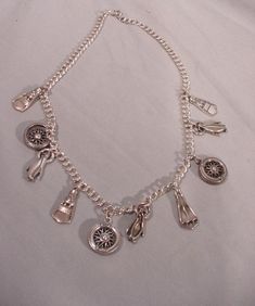 "This is such a cool necklace! Made by Nicole Miller, it is in silver tone metal. It has various \"charms\" - nicely spoked wheels, scuba-type flippers and even penguins. Who'd think these would all go together, but somehow they do! They all dangle from a nice, thick chain, approx. 19\" from clasp to clasp.  Good fun to \"wear or share.\" (58)" Charm Necklace Diy, Necklace With Charms, Cool Necklace, Charm Necklace Silver, Necklace Diy, Coral Stone, Cool Necklaces, Nicole Miller, Rhinestone Necklace