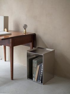 a book shelf sitting next to a wooden table