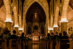 the inside of a church with pews and flowers