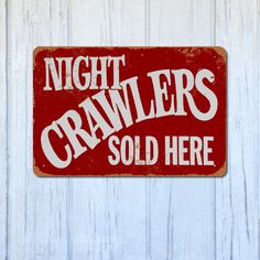 a red sign that says night crawlers sold here on a white wooden background with the words,'night crawlers sold here '