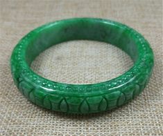 59mm Emerald Green Hand carved Moire Pattern Jadeite Jade #432 Bangle  Bracelet Love this jadeite bangle? Email us with questions. Size:  59mm x 12mm Weight: tbd This is a beautiful jadeite bangle! Subtle and rich.   Jadeite is a very gentle and strong healing stone that will help amplify the body's natural self-healing capacity. Oval Carved Jade Jewelry, Carved Jade Bangle Bracelet, Carved Oval Jade Jewelry, Green Carved Bracelet As A Gift, Carved Jade Bangle As A Gift, Green Carved Bracelet For Gift, Green Carved Bracelets As Gift, Green Carved Round Bangle, Round Carved Jade Jewelry