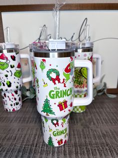 the grinch coffee mugs are decorated with festive holiday designs and christmas trees