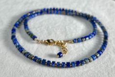 "💎 DE T A I L S * Handmade in Canada * Genuine Lapis Lazuli heishi gemstones (6mm) * 24k gold plated Miyuki glass beads * Adjustable Length: 18\" plus 2\" gold filled chain extender * 14 gold filled accent beads (3mm) * 18 gold filled lobster clasp  * Gemstones are 100% genuine 💎    LAPIS LAZULI A stone of wisdom, intuition, and truth, Lapis Lazuli is a powerful crystal for anyone seeking to deepen their connection to self. It encourages self-awareness, allows self-expression and reveals inner truth.  This stone stimulates clarity and   creativity. It releases stress and bring deep inner peace. Lapis Lazuli inspires confidence, bonds relationships, and aids in expression of feelings and emotions." Gift Gemstone Beaded Necklaces With Heishi Beads, Gift Gemstone Heishi Beads Necklace, Gift Gemstone And Heishi Beads Necklace, Gift Jewelry With Natural Stones And Heishi Beads, Gift Lapis Lazuli Beaded Necklaces With Round Beads, Lapis Lazuli Beaded Necklaces As Gift, Gift Heishi Beaded Necklace With Natural Stones, Heishi Beads Necklace With Natural Stones For Gifting, Gift Lapis Lazuli Beaded Necklace With Round Beads