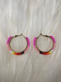 Handmade Brick stitch Hoop earrings with size 11/0 seed beads. The Earrings features 8 different colors of Beads, pink, light pink, white, yellow, orange, light red, dark red and black. The Hoop itself is golden colored.  And has a Diameter of 35mm/1.38 inches. Pink Hoop Earrings With Tiny Beads As Gift, Pink Hoop Earrings With Tiny Beads For Gift, Pink Hoop Beaded Earrings With Tiny Beads, Pink Tiny Beads Hoop Earrings, Pink Beaded Hoop Jewelry, Pink Small Hoop Beaded Earrings With Dangling Beads, Multicolor Tiny Beads Hoop Earrings, Multicolor Small Hoop Beaded Earrings With Dangling Beads, Multicolor Tiny Beads Small Hoop Earrings