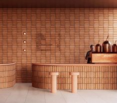 a counter with pots on it in front of a brick wall