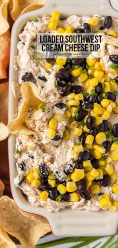 loaded southwest cream cheese dip with corn and black beans in a white bowl surrounded by tortilla chips