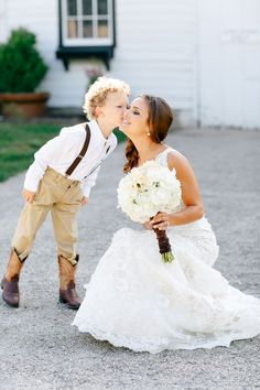 a young boy kissing his bride on the cheek