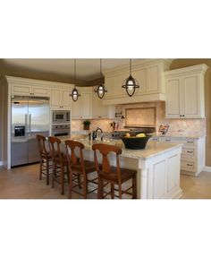 a kitchen with white cabinets and wooden chairs