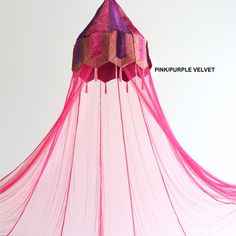 a pink canopy with fringes hanging from it's sides and the words pineapple velvet above it