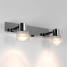 three light bathroom fixture in chrome finish with frosted glass shades