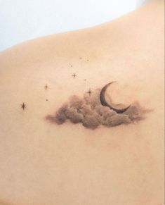 the back of a woman's stomach with a crescent and stars tattoo on it