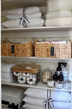 the shelves have baskets and towels on them