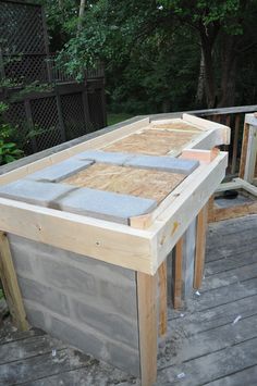 a wooden deck with some concrete blocks on it