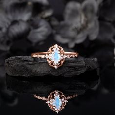 Our stylish, one-of-a-kind Moonstone & White Zircon ring, designed to exude vintage charm. Key Features: ▪︎ Captivating gemstone: 4 x 6 mm oval-cut Moonstone, that shimmers with a celestial glow, enhancing your presence in any setting. ▪︎ Artisanal Craftsmanship: Handcrafted by expert artisans, ensuring unique charm and superior quality. ▪︎ Designed for Comfort: The band is thoughtfully designed for a comfortable fit, perfect for everyday wear. ▪︎ Quick Processing and Shipping: Shipped same day Antique Oval Moonstone Ring, Elegant Opal Ring With Accent Stones For Promise, Vintage Gemstone Jewelry For Promise, Vintage Promise Jewelry With Gemstone, Topaz And Moonstone Ring For Wedding, Antique Moonstone Wedding Ring, Elegant Moonstone Crystal Ring With Rose Cut Diamonds, Moonstone Ring With Center Stone, Elegant Moonstone Ring With Rose Cut Diamonds For Wedding