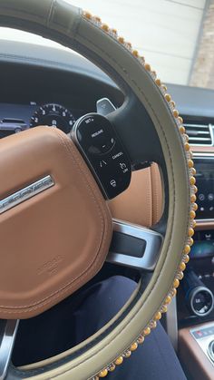 the interior of a car with an automatic steering wheel cover and dashboard controls on display