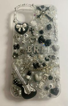 a cell phone case with many different items on the front and back cover, all covered in sequins