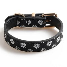 a black and white dog collar with flowers on it