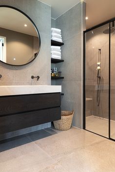 a bathroom with a sink, mirror and shower stall in it's own area