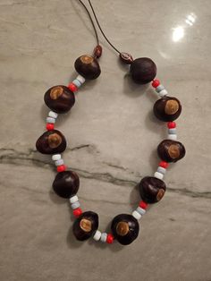 "Kid's Buckeye Necklace featuring 10 genuine Ohio Buckeyes and a stretchy lightweight nylon cord. Approximately 12\" from top to bottom when laid down flat on a surface." Ohio Buckeyes, Personalized Football, Skull Necklace, How To Make Beads, Chain Styles, Handmade Necklaces, Beading Patterns, Necklace Etsy, Beaded Necklace