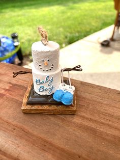 a cake made to look like a snowman sitting on top of a wooden table