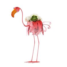 a pink flamingo with flowers in it's beak is standing on its legs