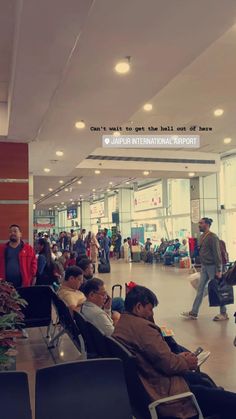 many people are waiting for their luggage at the airport