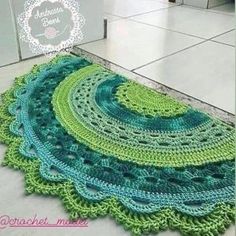 there is a crocheted rug on the floor