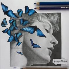 a drawing of a woman's face with blue butterflies on her head, and pencils next to it