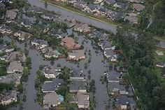 an aerial view of flooded homes in a neighborhood