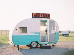 an old trailer is parked in a field with the word photo on it's roof