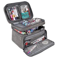 an open suitcase filled with lots of crafting supplies on top of a white background