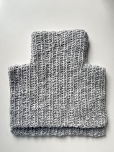 two gray knitted napkins sitting on top of each other