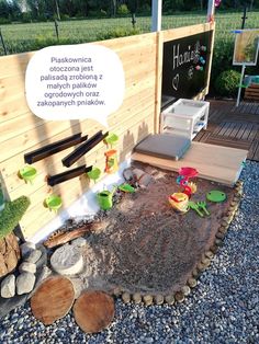 an outdoor play area with rocks and gravel