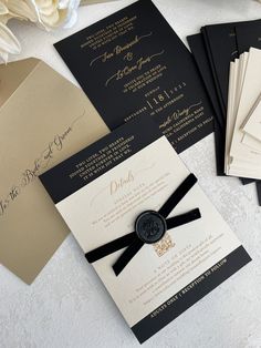 the wedding stationery is laid out on top of each other and ready for guests to arrive