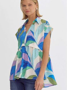 Brighten your wardrobe with the vivid allure of our Babydoll Summer Garden Watercolor Top. This piece dazzles with its vibrant, watercolor-style print featuring an array of blues, greens, and purples, designed to evoke the serene beauty of a summer garden. This colorful top is ideally complemented by neutral bottoms, such as classic denim jeans or crisp white trousers. Accessorize with simple, elegant jewelry to let the top's bold print take center stage. SIZE & FIT Fit is true to size Model is