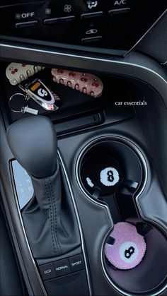 the interior of a car with buttons and steering wheel knobs in it's center console