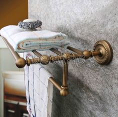 a towel rack with two towels on top of it next to a wall in a bathroom