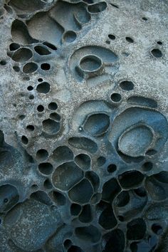 an image of water bubbles in the sand with black and white colors on it's surface