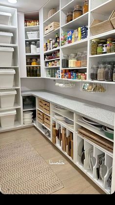 an organized pantry with white shelving and bins