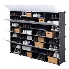 the shoe rack is holding several pairs of shoes and other items, including two large bins