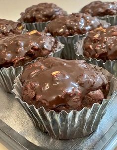 several chocolate muffins sitting on top of a metal tray