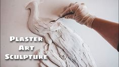 a person is painting a white bird with paint on it's wings and the words plaster art sculpture