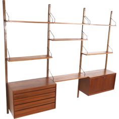 three wooden shelving units with drawers and shelves